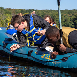 Biology student sample lake water at Bear Lake