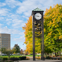 The clock tower with fall color in the trees