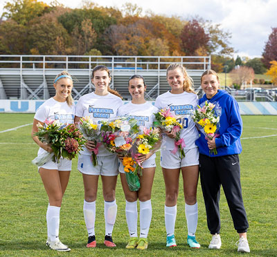 senior soccer players with flowers