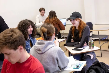 students talking together in class