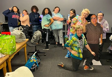 A handful of students (from left): Pamela Pantin, Belinda Paine, Aurora Endres, Michael Morales, Calysta Standard, Ella Maines, Kaylee Gabalski, Rylee Crandall and (keeling) Quentin Moss are relieved and sleepily celebrating after having recently submitted their films for judging. The students, from two different teams, were encouraged to bring along overnight gear, such as blankets, pillows or stuffed animals. That created an opening for the actor/filmmaker Danny DeVito cutout, who took on the role of team