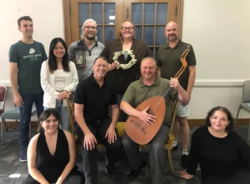 SUNY Fredonia alumni and faculty gathering for a group photo ahead of the Buffalo Opera Unlimited production of “The Marriage of Figaro” are (front row, from left): Nicole Brendel, SUNY Distinguished Teaching Professor Paul Mockovak, Tim Flynn and Jamie Gangemi; (back row) Matt Marco, Eun Joo Jeon, Zachary Bills-Warman, Amie Adams and Dr. Rob Strauss.