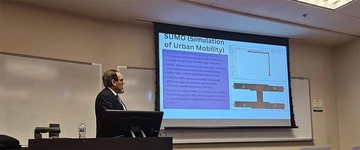 Dr. Junaid Zubairi presents a slide during the research seminar he held at Kennesaw State University in Atlanta.