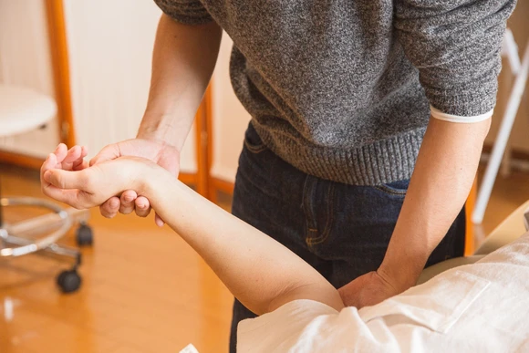 Physical therapist working with patient