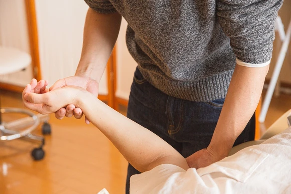 Therapist working with patient on table. The Fredonia Exercise Science degree program  leads to a variety of exciting careers.