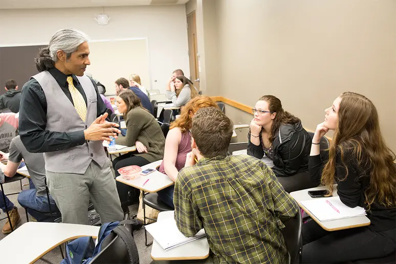 faculty member in discussion with students