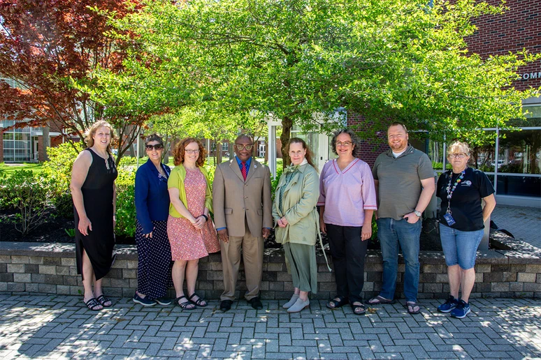 group of Chancellor's Award recipients standing outside with President Kolison