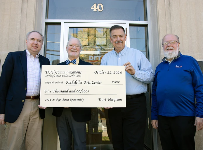 sponsor representatives and college officials holding large check