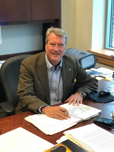 photo of Mark Geise at his desk