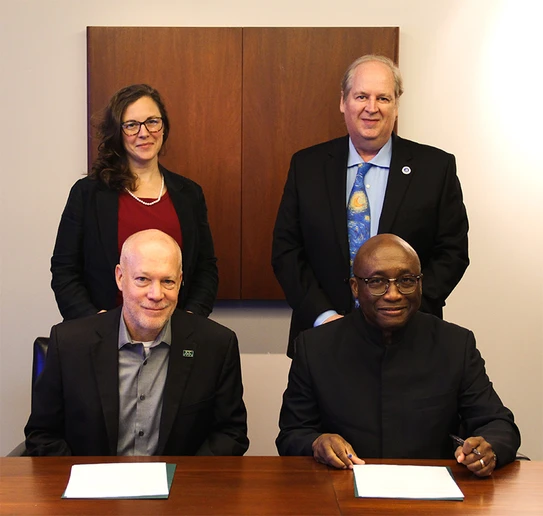 SUNY Fredonia and Jamestown Community College administrators seated and standing