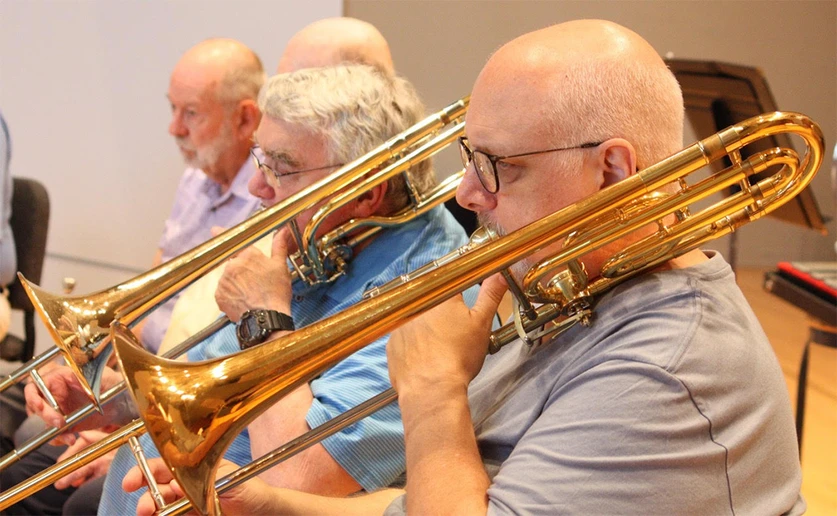 band members playing trombone in a rehearsal