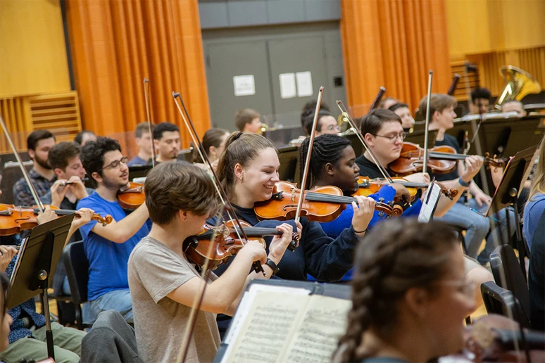 orchestra members rehearse