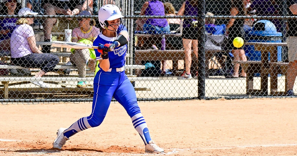 softball player in action ready to strike ball