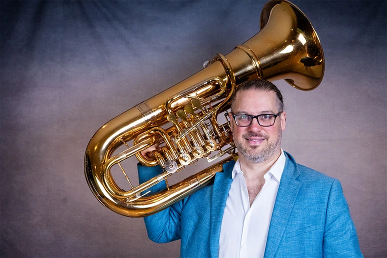 tuba player holding instrument