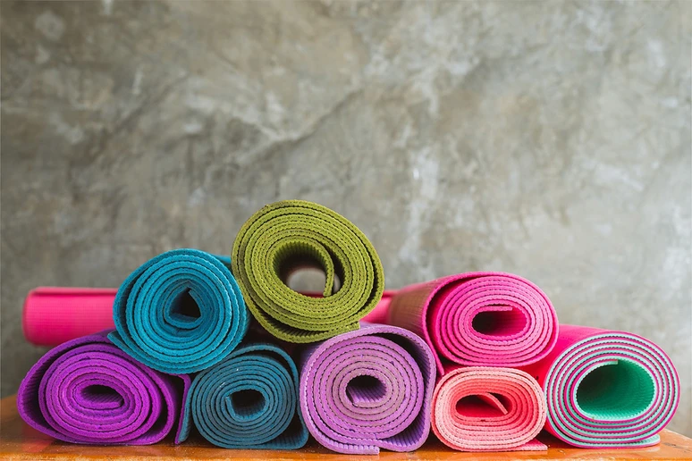 pile of rolled yoga mats