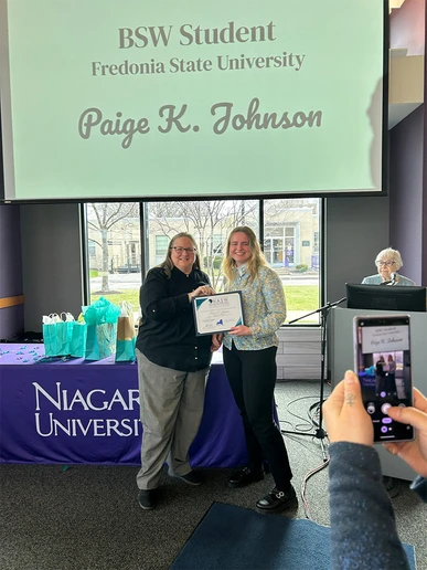 Paige Johnson (right) receives her Social Work Student of the Year award from Cheryl Eberl, of the National Association of Social Workers-New York State Western Division.