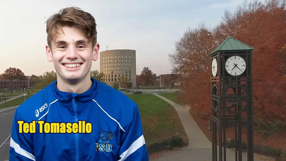 Ted Tomasello in front of Maytum Hall and clock tower