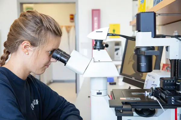student at microscope