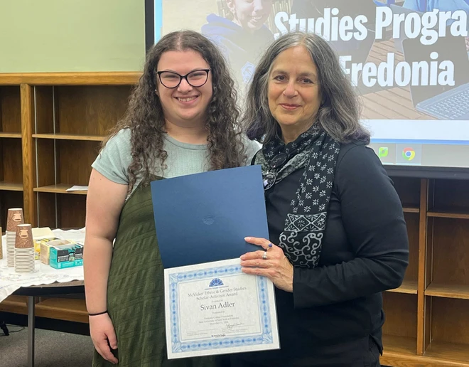 scholarship recipient and faculty member with certificate