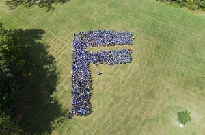 students lined up in the letter F on the lawn