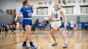 Grace Alexander with another player playing basketball