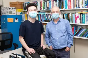 Fredonia graduate Aierkan Salayding (left), with Dr. Ziya Arnavut.