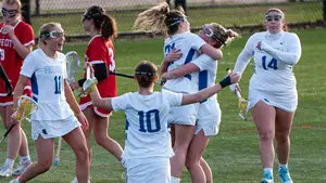 lacrosse players celebrating on the field