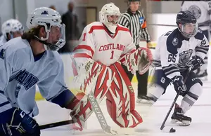 three hockey players in action