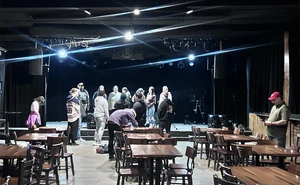 Students in MUSB 425: Music Marketing and Promotion check out the stage at the Cave, a Buffalo, NY, music venue.