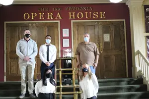 students and director standing on opera house steps