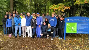 Dr. Phillips and friends in front of trail sign