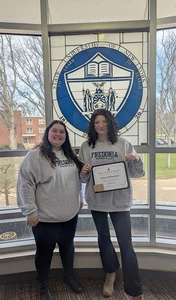Aileen Richardson displays her Resident Assistant of The Month certificate presented by Kasling Hall Residence Director Sabrina Sosa.