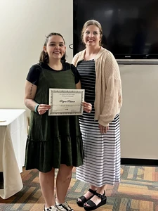 Reyna Reisner, with her Growth Award certificate, and Briana Postle.