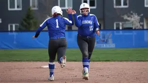 two softball players high fives