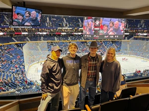 Dr. Sungick Min (far left) and students (continuing from left) Jack Hoadley, Evan Barrett and Arianne LeRouzes, have a commanding view of KeyBank Center at a recent Buffalo Sabres’ NHL game.