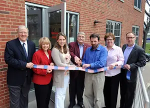 Ribbon being cut in front of building