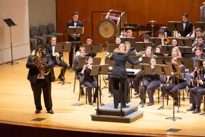 student performing with wind ensemble