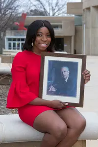 Monica Manney with photo of Dr. Oscar Lanford