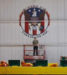 Alisia Glasier stands under mural at Dunkirk Specialty Steel