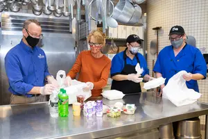 staff assembling lunches