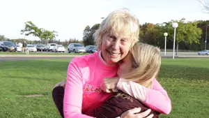 Carol "Stash" Stanley embraces student Genielle Byczynski, the first recipient of the scholarship "Stash" started in memory of her mother.