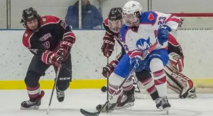 Luke Rivera fights for the puck Friday vs. Bryn Athyn.