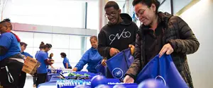 students assembling backpacks