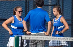 two tennis players and their coach