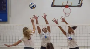 Kailey Falk (6) and Selena Brown (24) go for the block.