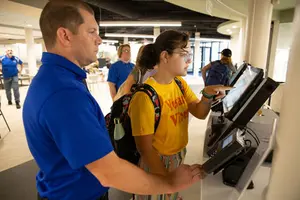 student orders at kiosk at Willy Cs