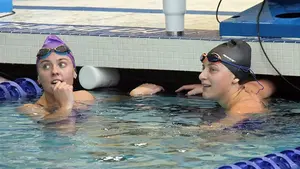 Fredonia State swim team in pool, swimming