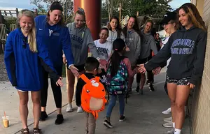 Student-athletes greet area youngsters on their way into school