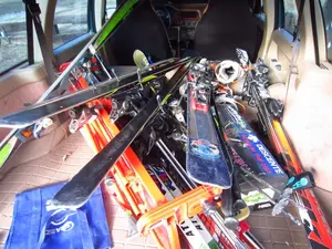 Skiis stacked in a car.