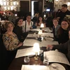 alumni sitting around a table in a restaurant